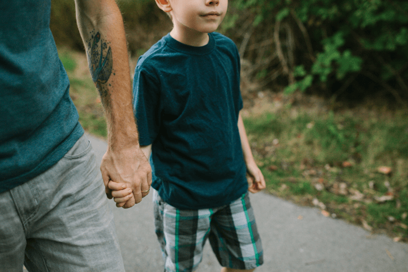 father and son holding hands
