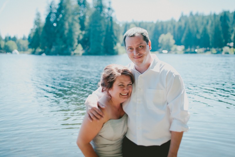 Bride and groom standing in the water for their wedding portraits at Island Lake Park in Silverdale. 