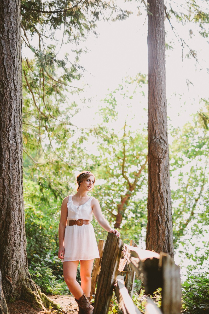 Rustic chic high school senior session, with girl in a white dress in and formal up-do hairstyle. 