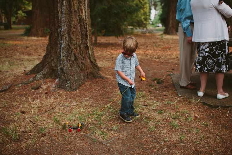 Small boy with toy at a wedding at Lincoln Park. 