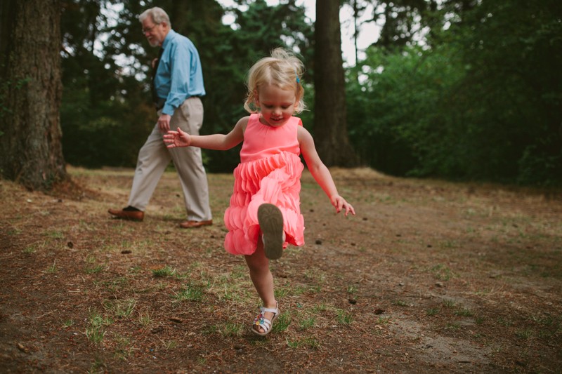 Little girl in a pink dress playing at a park. 