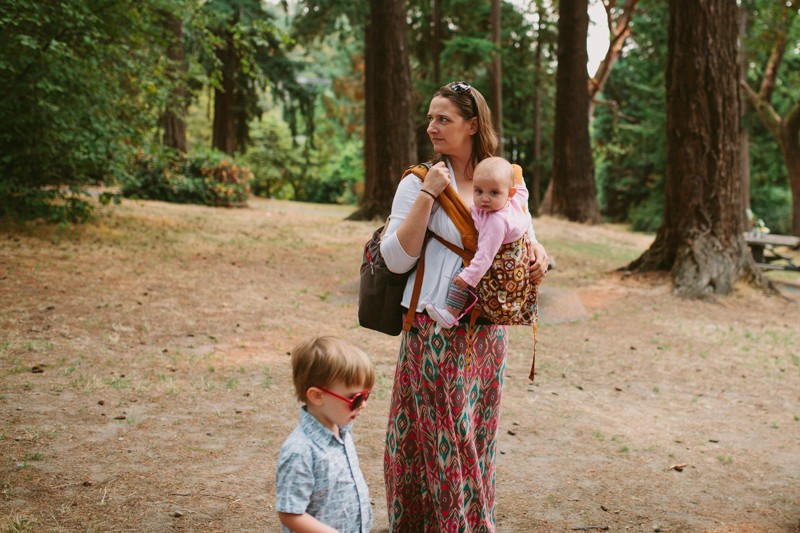 Wedding guest wearing baby in a carrier.