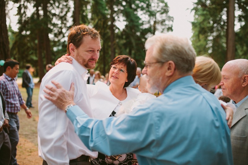 Groom with his father and mother of the bride after ceremony. 