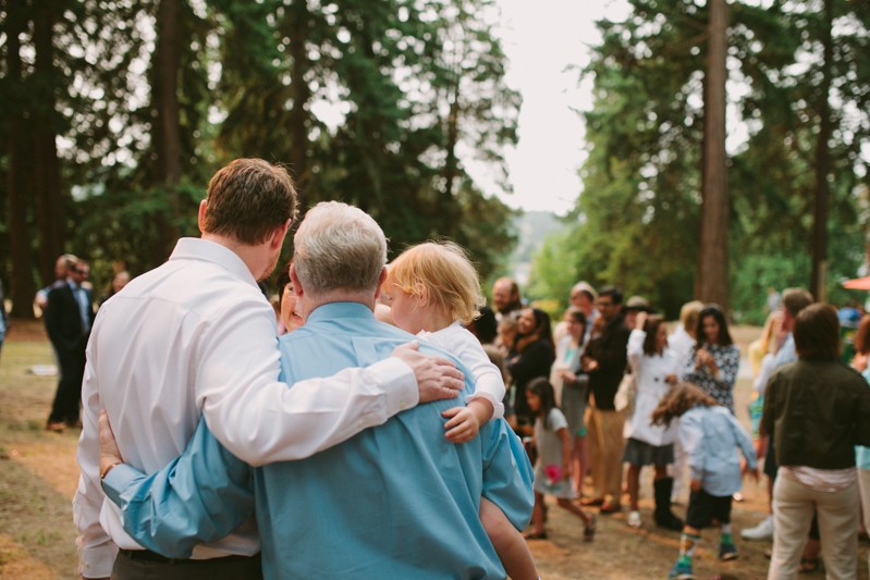 Groom and his father hug after wedding ceremony. 