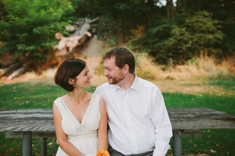Lovely bride in a beaded v-neck wedding dress, with a simple short hairstyle. 