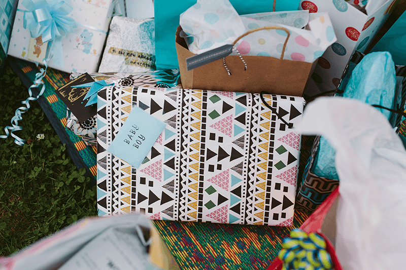 Baby shower presents with fun patterned wrapping paper. 