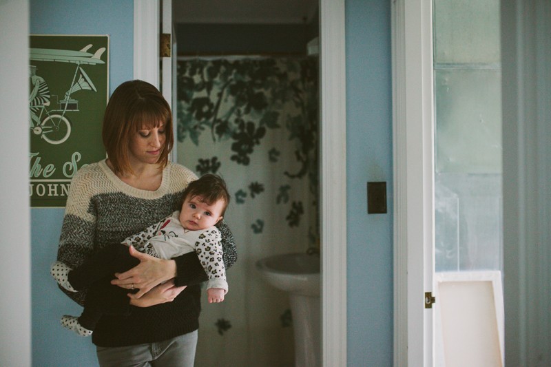Modern at-home portraits of a young, indie mom holding her baby girl. 
