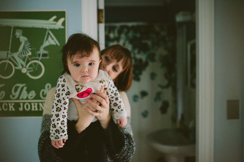 At home portrait session on Bainbridge Island, with mom holding her baby girl. 