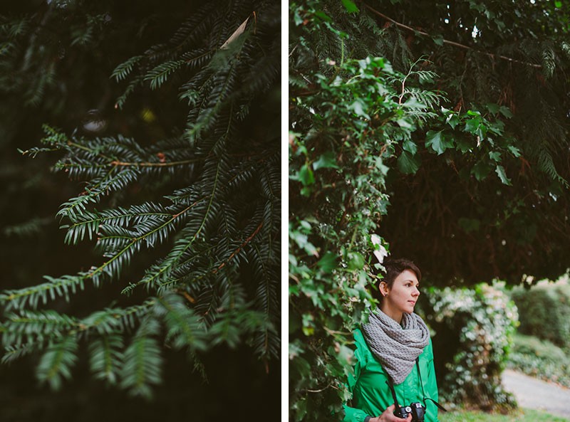 Natural portraits in Indianola, Washington, with woman standing under a vibrant hedge.