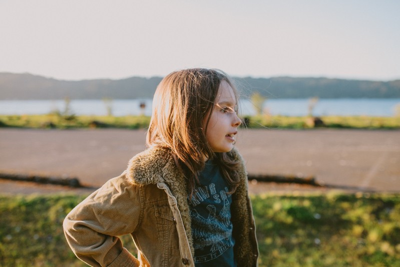 Twanoh State Park lifestyle portrait session, with boy in a sherpa-lined coat and long hair.