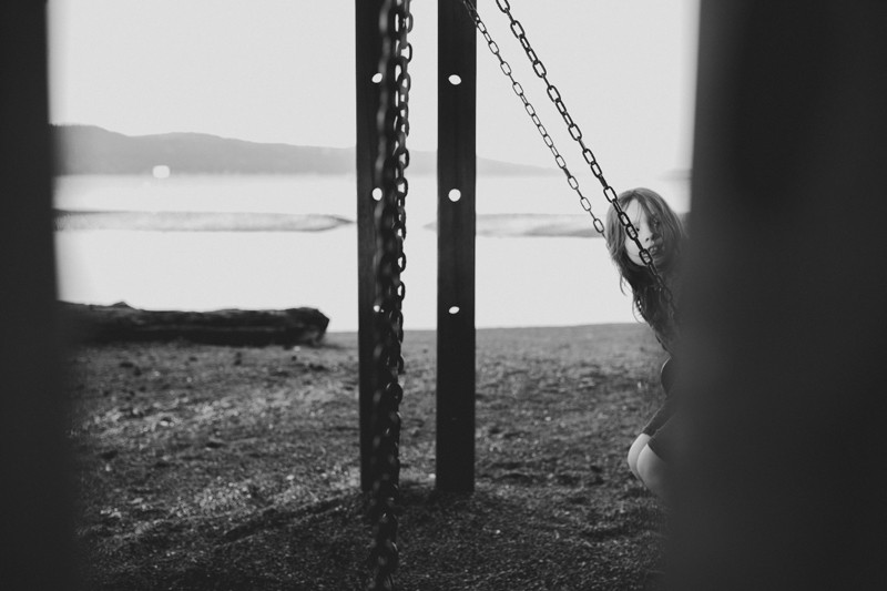 Boy in a swing at Twanoh State Park, along the Hood Canal in Union, WA.
