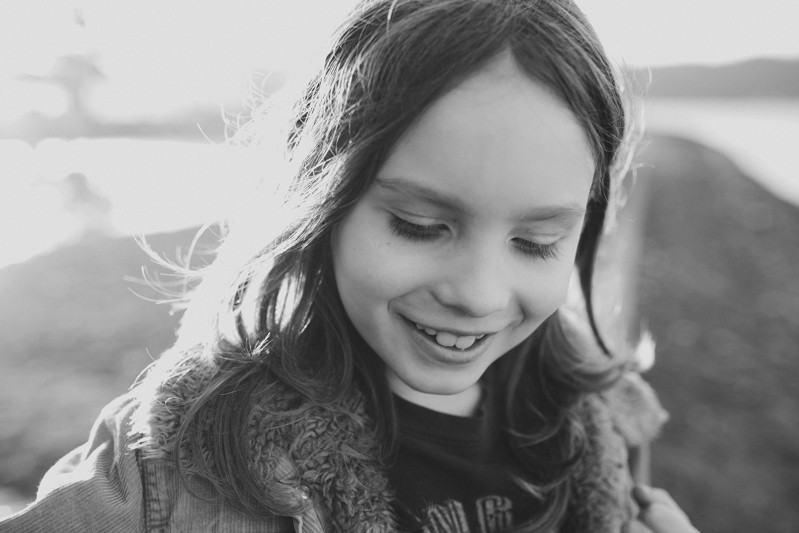 Boy with long hair, in a sherpa-lined coat, at Twanoh State Park.