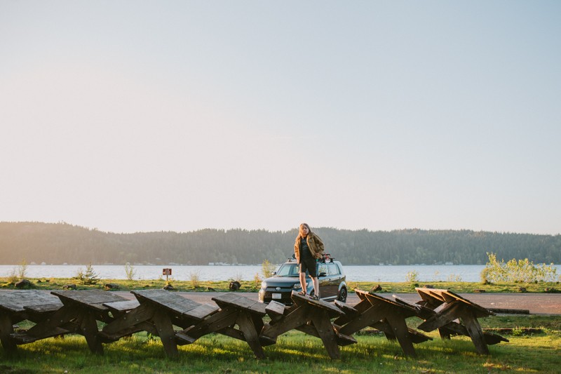Boy standing on stacked picnic tables at Twanoh State Park.