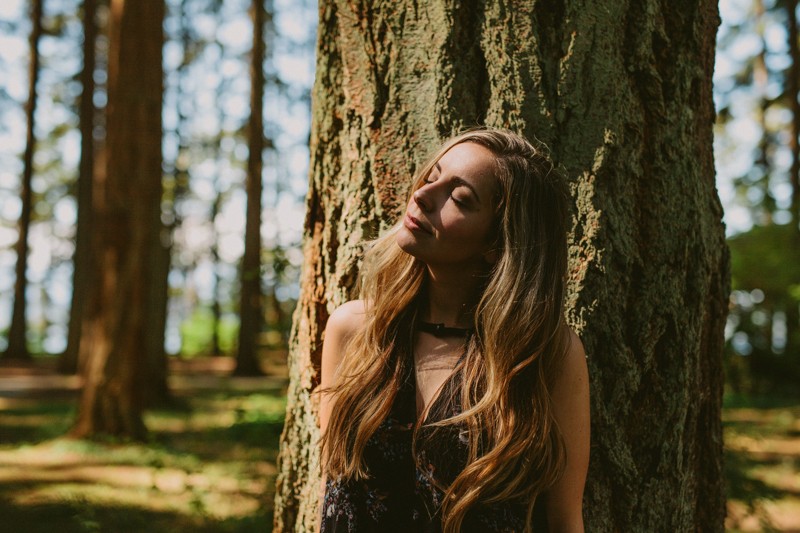 Adventurous woodsy portraits, with model standing in sunlight at Kitsap Memorial State Park.
