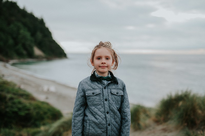 Child standing above the beautiful beach at Fort Worden at sunset, in Port Townsend, WA.