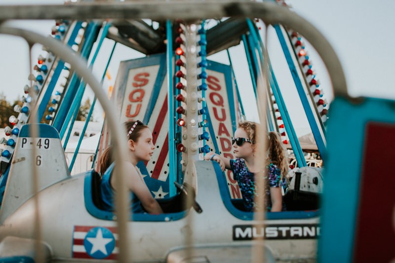 Kids riding an old airplane ride at the Kitsap County Fair.
