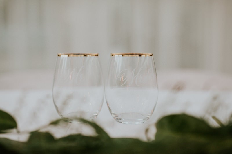 Gilded and inscribed his and hers stemless wine glasses. 