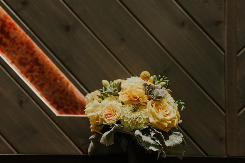 Modern yellow floral bouquet, with Roses, Dahlias, Succulents, and Billy Balls.