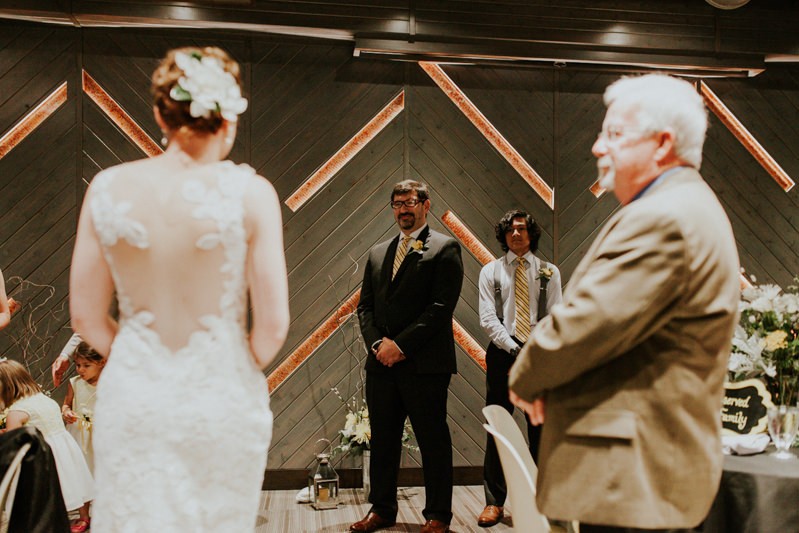 Groom smiles as he sees his bride during the processional.