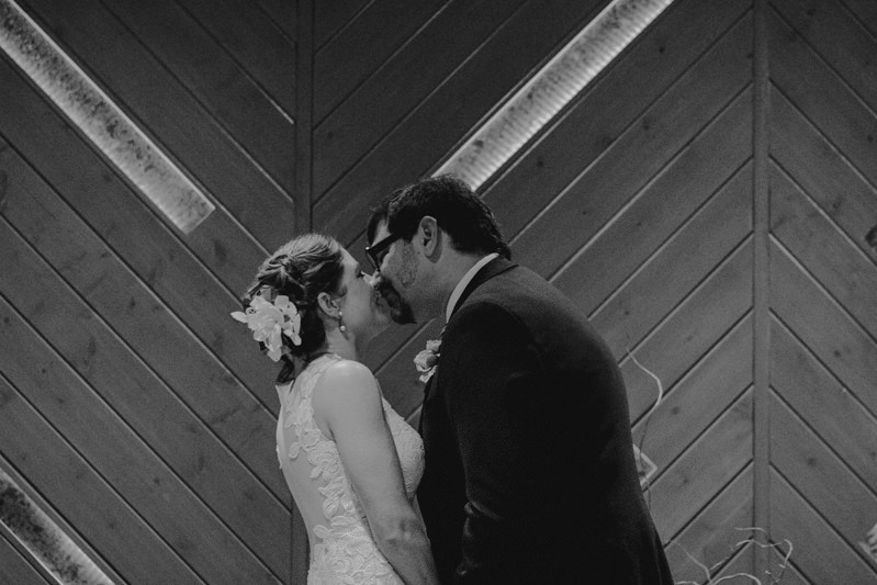 The groom kisses his bride, during their simple ceremony at The Pine Room in Tacoma.