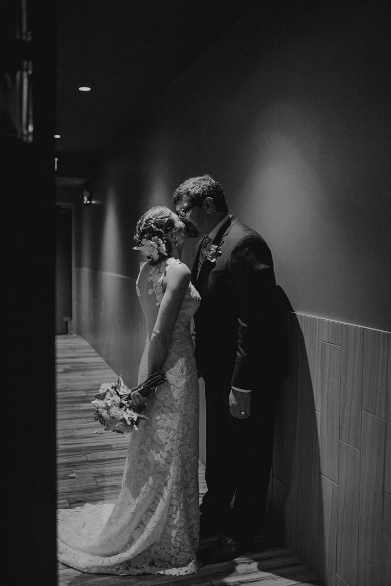 Just married and in love; bride and groom kissing after their ceremony.