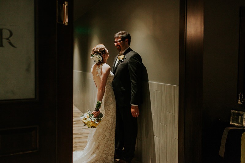 Bride and groom smiling and cuddling after their ceremony.