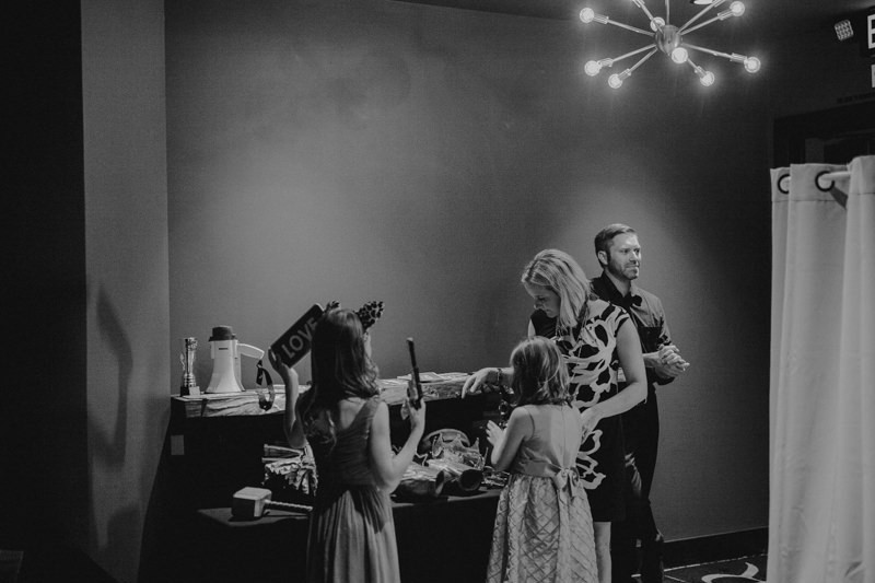 Wedding guests playing with props for a photo booth.