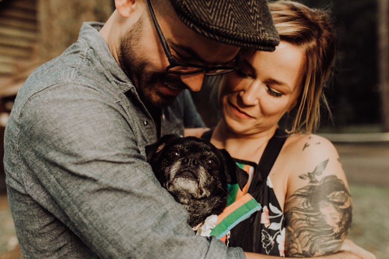 Fun Hood Canal engagement session with bride and groom snuggling their cute dog. 