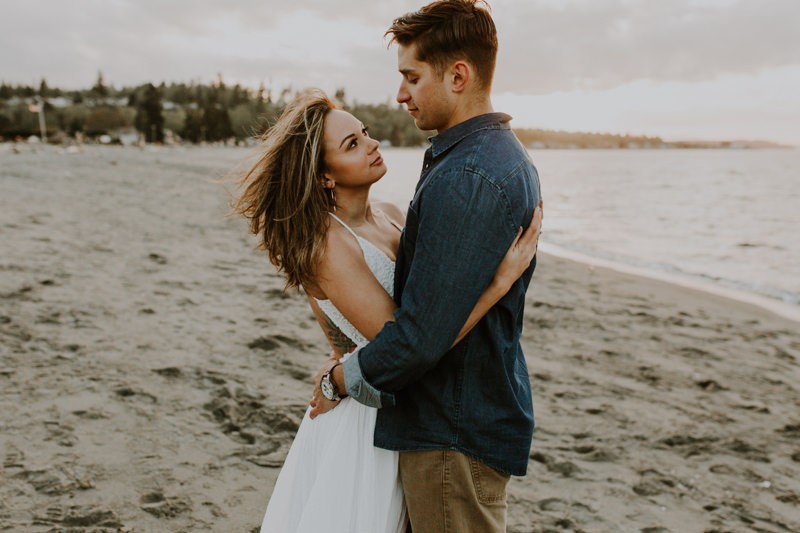 Romantic sunset engagement session on sandy beach on the Kitsap Peninsula. 